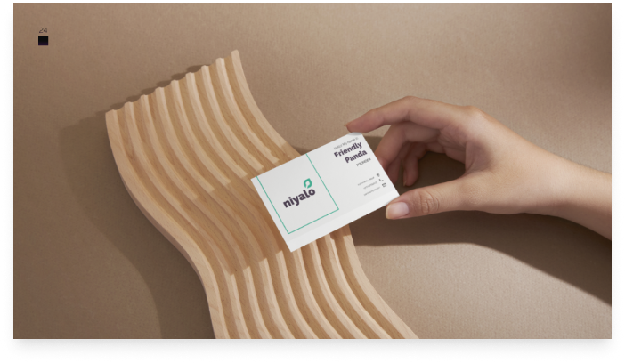 Hand holding a business card, showcasing niyalo branding.